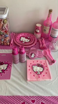 hello kitty party supplies on a table with pink polka dot paper plates and napkins