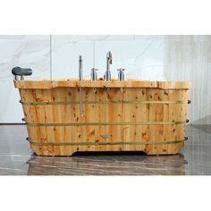 a large wooden tub with two faucets on the top and one faucet at the bottom