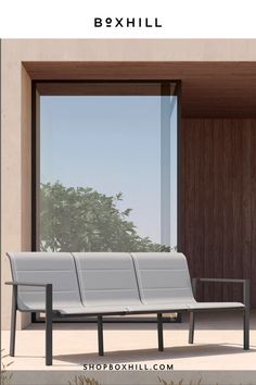 a white bench sitting in front of a window