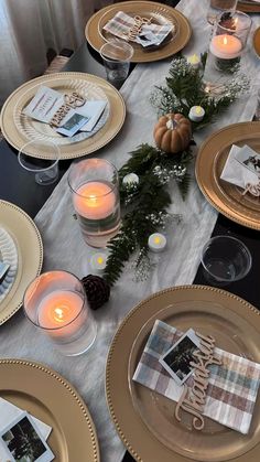 the table is set with gold plates and place settings