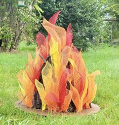 a fire pit in the middle of some grass