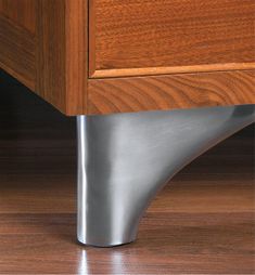 a close up view of a drawer with wood and metal trim on the bottom part