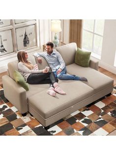 a man and woman sitting on top of a couch