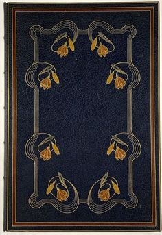 an old book with gold flowers on blue leather cover, and brown trim around the edges