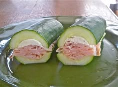 a sandwich cut in half sitting on top of a green plate