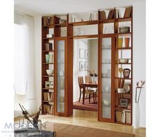 an open bookcase with glass doors in a living room