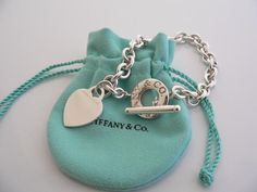 Overview:Offered for sale is a wonderful and gorgeous Tiffany & Co. Sterling Silver Heart Toggle bracelet.  Definitely a Tiffany piece that you will get your money's value for.  It works perfectly with pretty much any attire your put on, AND is a great statement piece.  The chain for this specific bracelet very substantial, and the pretty Tiffany heart just goes perfectly with it.   It is the perfect bracelet that fits a lifestyle on the go -- can be worn to pretty much any occasion!  It i Tiffany Inspired Jewelry Sterling Silver, Tiffany Charm Bracelets Tiffany & Co., Tiffney And Co Jewelry, Luxury Heart Bracelet As A Gift, Luxury Valentine's Day Charm Bracelet, Elegant Valentine's Day Jewelry, Luxury Charm Bracelet With Heart Charm For Gift, Luxury Charm Bracelet With Heart Charm As A Gift, Luxury Charm Bracelet For Valentine's Day