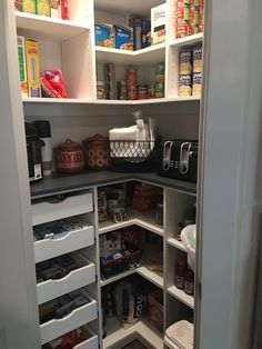 an organized pantry with lots of food in the cupboards and on the shelves is shown