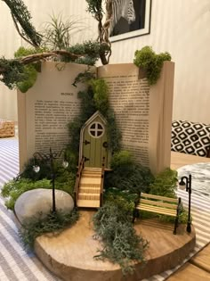 an open book sitting on top of a wooden table next to a tree and bench