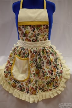 a child's apron and dress made to look like it has flowers on it