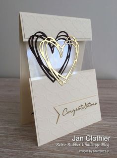 a white card with two hearts on it and the words congratulations written in black ink