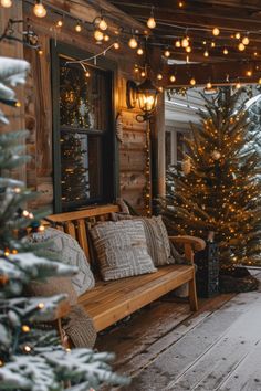 a wooden porch covered in christmas lights next to a tree