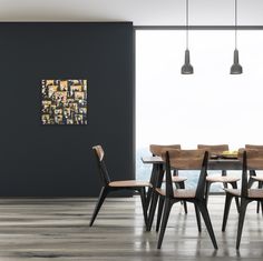 a dining room table with chairs and a painting on the wall