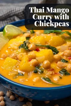 thai mango curry with chickpeas in a blue bowl and garnished with cilantro