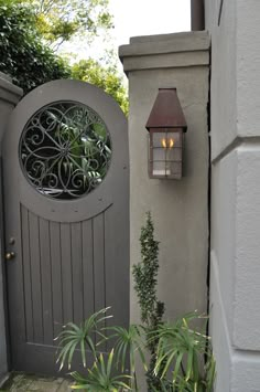 an outdoor gate with a lantern on it