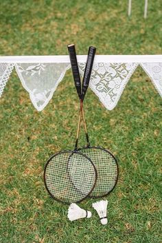 two tennis racquets are sitting on the grass next to some bunting