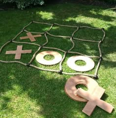 an outdoor game set up in the grass with two crosses and one letter on it