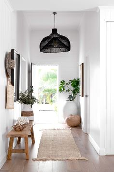 an image of the inside of a house with plants on the wall and in the hallway