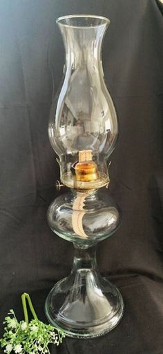 a clear glass vase sitting on top of a table next to a small flower pot