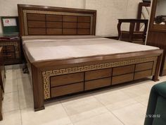 a bed with wooden headboard and foot board in a room filled with other furniture