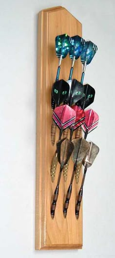 there are many different types of toothbrushes hanging on the wall in this holder