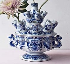 a blue and white vase with flowers in it