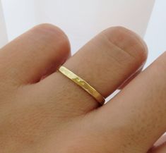 Thick and durable. This uniquely hammered gold band is made in high-quality 14k solid gold material and made to order just for you. Wear this band alone or stack it with other dainty rings for a stacked looked! Great for gifting or as a wedding band. Made in Los Angeles, CA! Fast Shipping: It will take 1-5 business days to send out your item. Free priority shipping included! Packaging: Comes in a beautiful gift box and bow, ready for gift-giving! Ring Size: Width: 2.2mm Thickness: 1mm Material: Thick Gold Band, Thick Gold Ring, Gold Band Wedding Ring, Gold Ring Wedding, Dainty Rings, Gold Rings Simple, Hammered Ring, Opal Ring Gold, Fire Opal Ring