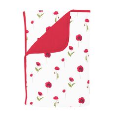 a blanket with red flowers and green leaves on white background, folded up to the side