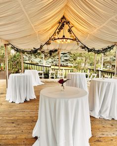 the tables are covered with white tablecloths and chairs for an outdoor wedding reception