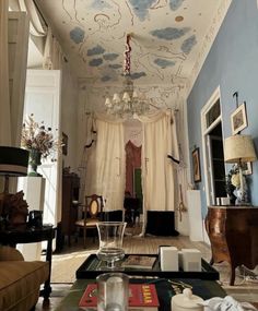 a living room filled with furniture and a chandelier