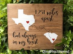 a wooden sign that says, 25 miles apart but always in my heart with two hearts on it