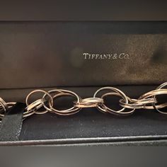 Presented Here Is A Gorgeous Bracelet From Tiffany & Co. The Bracelet Is A Series Of Interlocking Rings That Are Rubedo And Sterling Silver. Rubedo Is An Alloy Made From 31% Gold, 55% Copper And The Remaining Zinc And Silver. It Makes For A Strong And Beautiful Metal. This Bracelet Was One Of The 1837 Bracelets. A Fabulous Bracelet For Any Jewel Collection. The Bracelet Has A Clasp Closure. Interlocking Rings, Tiffany And Co Bracelet, Tiffany Co Jewelry, Gorgeous Bracelet, Tiffany & Co., Womens Jewelry Bracelets, Silver Gold, Copper, Women Jewelry