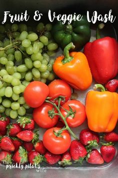 fruit and veggie wash in a container with strawberries, grapes, tomatoes, bell peppers, and green beans