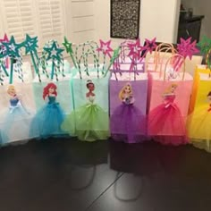 there are many bags with princesses in them on the table, all lined up