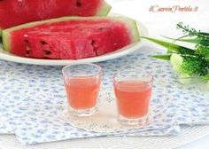 watermelon slices on a plate with two glasses next to one piece of watermelon