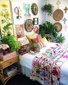 a bedroom with lots of plants and pictures on the wall