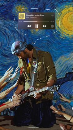 a man holding a guitar in front of a painting with many people reaching for it