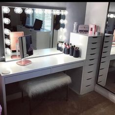 a vanity with lighted lights and drawers