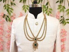 Elevate your sherwani with this timeless Gold Kundan Groom Necklace, an exquisite piece of Indian groom jewelry. This stunning mala is designed to perfectly complement your sherwani, adding a sophisticated and regal touch to your look. Crafted with intricate detailing and high-quality materials, this groom wedding necklace is the ideal accessory for making a memorable impression on your special day. Elevate your sherwani with this timeless piece and embody the grace and tradition of Indian weddings. Color Disclaimer: While we make every effort to display the colors accurately, please note that actual colors may vary slightly due to your display settings and photography lighting. If you have any queries about this product, do not hesitate to ask us. Just give us a message and we will be hap Necklace Emerald, Kundan Necklace