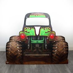 the monster truck is painted green and red