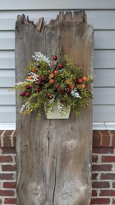 an old piece of wood has a planter on it