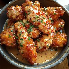 a bowl filled with chicken wings covered in sauce