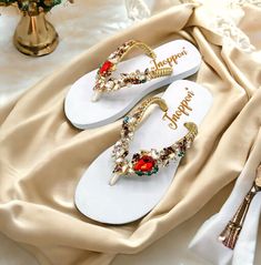 Description The beautiful rhinestone and customizable Flip Flops for the beach brides, bridesmaids, vacation, honeymoon or any occasion you desire to look gorgeous. Perfect in any outfit! Being unique and stunning on design, these flip flops must be your must-have item! The sandal is anti-slip, comfortable and durable as it is made from high quality rubber from the South of Thailand, where is famous for the best rubber tree. Moreover, the crystals are decorated on the sandal with effective adhesive glue and knitting threads by hand stitching. Don't worry when you walk on the beach or use it in the rainy season. For anyone who loves a real handmade product, don't miss it out! Product Description: - Thailand High-Quality Rubber Sole - Luxury Crystals/Rhinestones  - High-quality PU gold threa Summer Wedding Shoes With Rhinestones And Round Toe, Summer Wedding Shoes With Rhinestones, Elegant Party Flip Flops With Open Toe, Elegant Open Toe Party Flip Flops, Elegant Party Flip Flops, Embellished Sandals For Beach Party, Embellished Sandals For Beach Season Parties, Gold Sandals For Summer Beach Wedding, Summer Party Flip Flops With Rhinestones