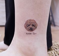 a small dog's face is shown on the ankle