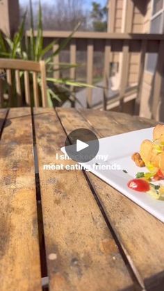 a white plate topped with food on top of a wooden table