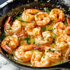 a skillet filled with shrimp and sauce