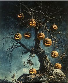 a tree with pumpkins hanging from it's branches in front of a full moon sky