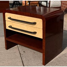 a wooden table with two drawers on the top and one drawer open to reveal something