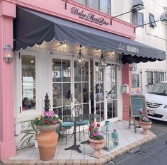 an outside view of a restaurant with potted plants