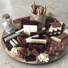 a platter filled with lots of different types of chocolates and marshmallows